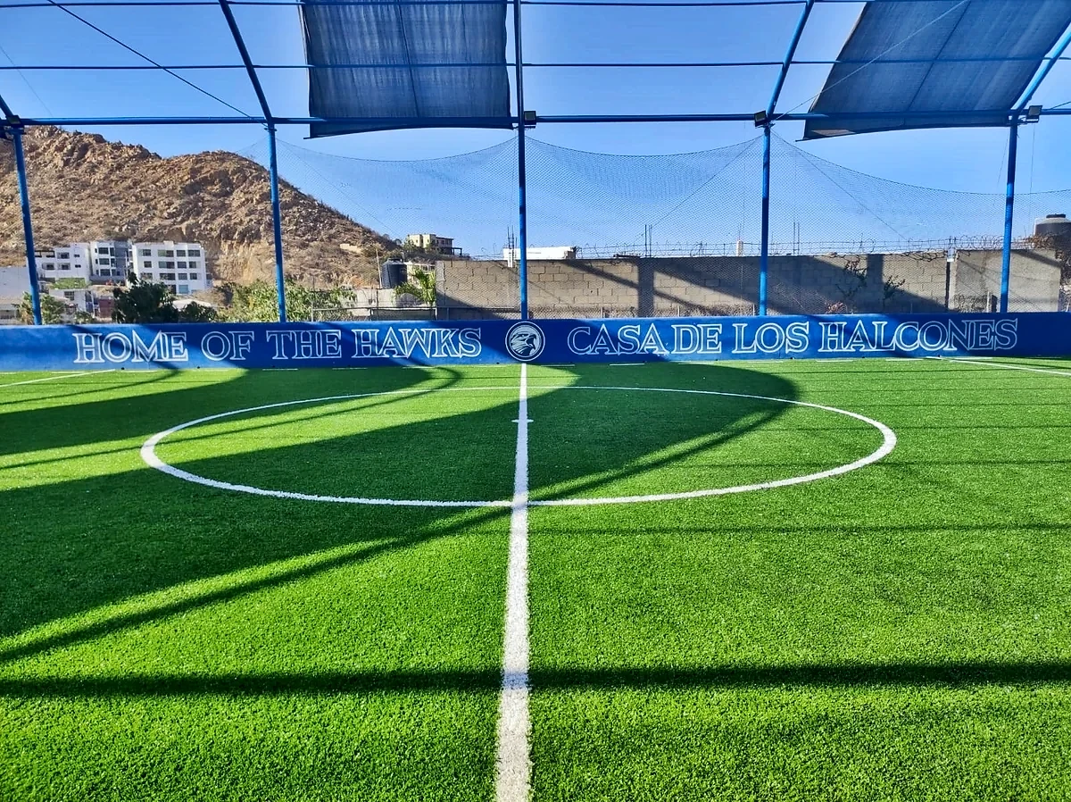 Cancha de fútbol rápido con pasto sintético en Colegio El Camino, Los Cabos, Baja California Sur: la cancha desde la línea lateral
