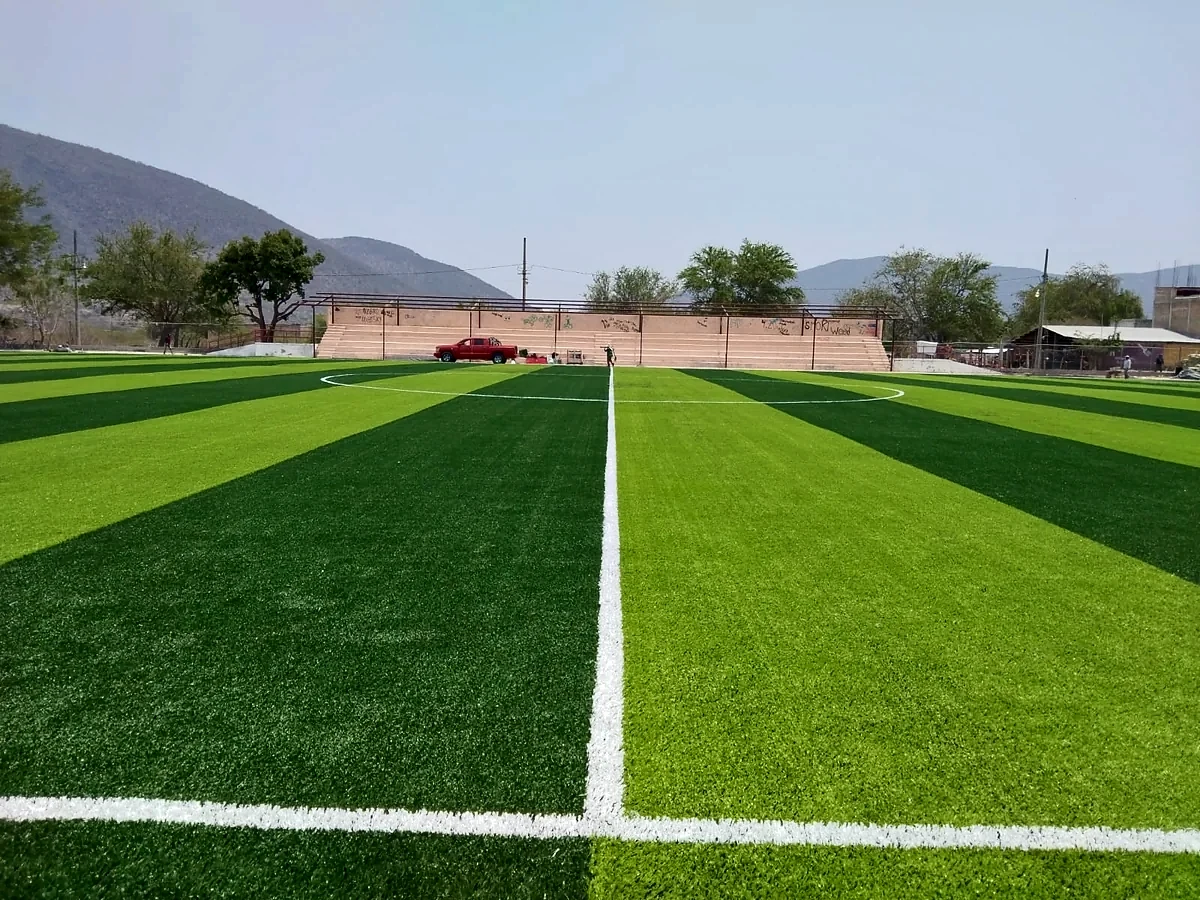 Cancha de fútbol soccer con pasto sintético en Empresa KRONON, Mártir de Cuilapan, Guerrero: líneas de juego insertadas en el pasto