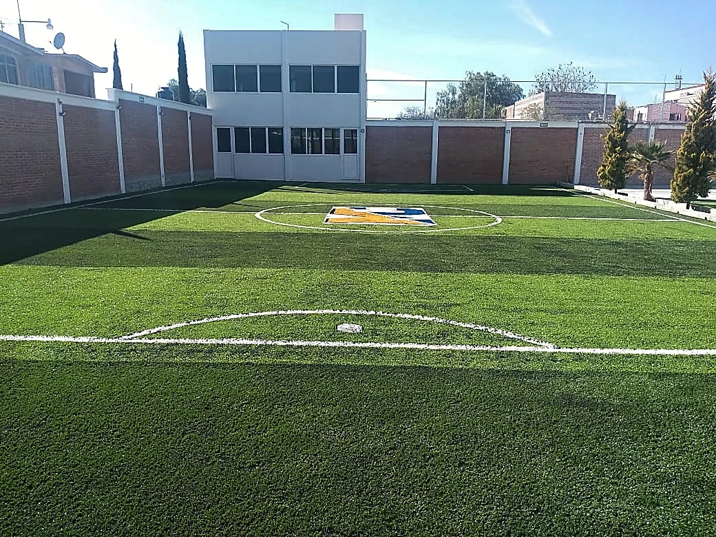 Cancha de fútbol 5 con pasto sintético en Secundaria Marie Curie, Actopan, Hidalgo: otra vista de la cancha