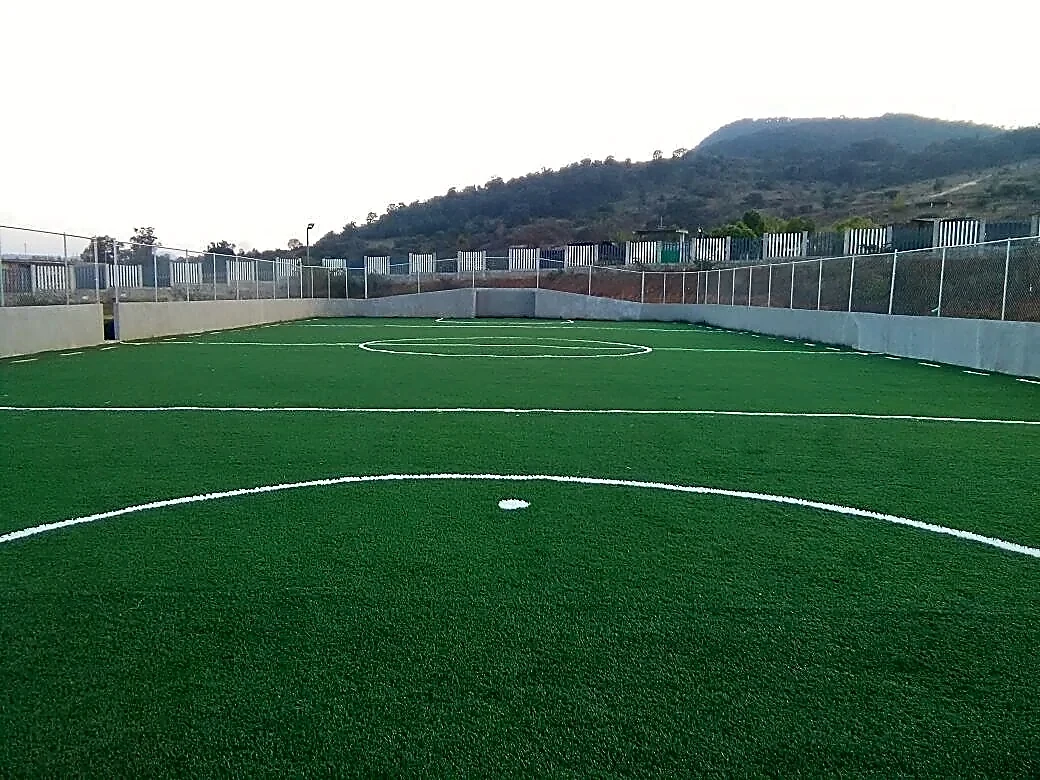 Cancha de fútbol rápido con pasto sintético en Unidad Deportiva Acuitzio del Canje, Michoacán: líneas de juego insertadas en el pasto