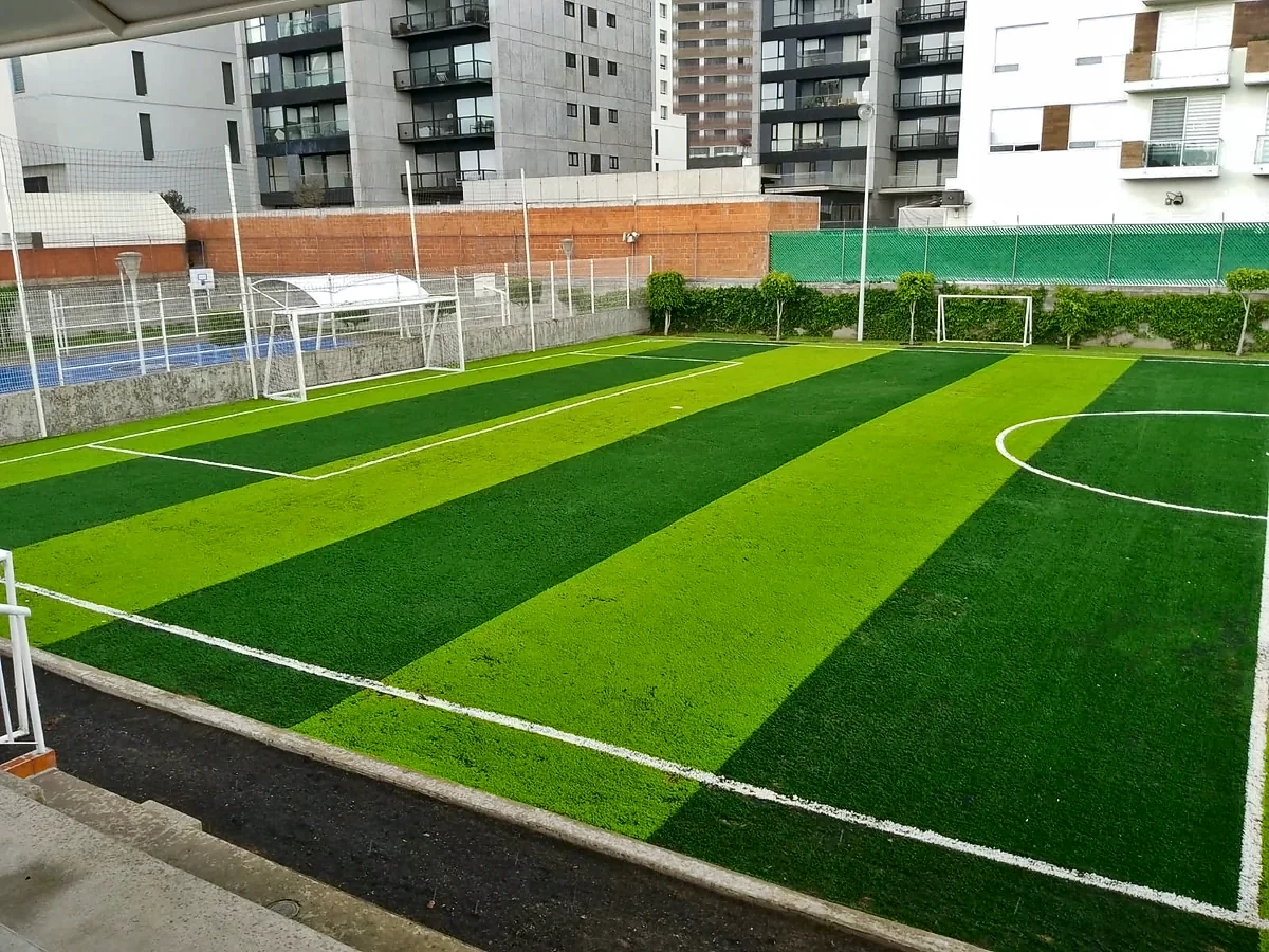 Cancha de fútbol 7 con pasto sintético en Colegio México Nuevo, Cholula, Puebla: pasto sintético deportivo recién cepillado