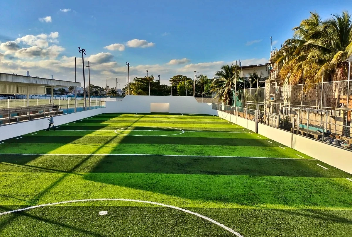 Cancha de fútbol rápido con pasto sintético en Multideportivo Salina Chica, Isla Mujeres, Quintana Roo: líneas de juego insertadas en el pasto